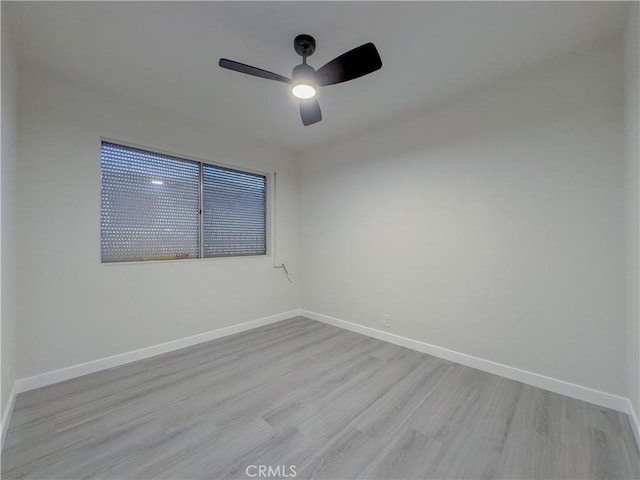 empty room with light hardwood / wood-style flooring and ceiling fan