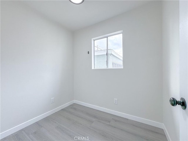 unfurnished room with light hardwood / wood-style floors