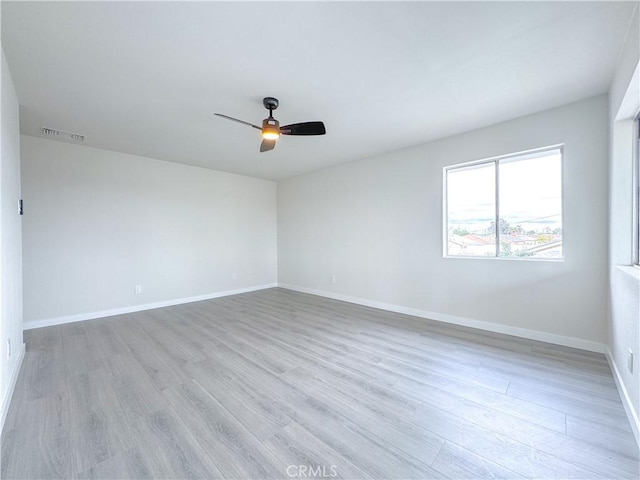 empty room with ceiling fan and light wood-type flooring