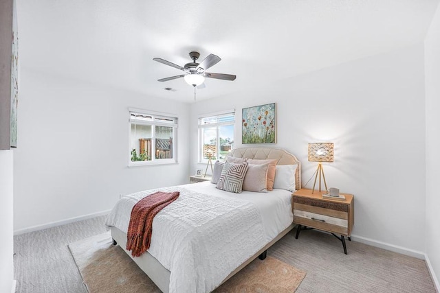 bedroom with light colored carpet and ceiling fan