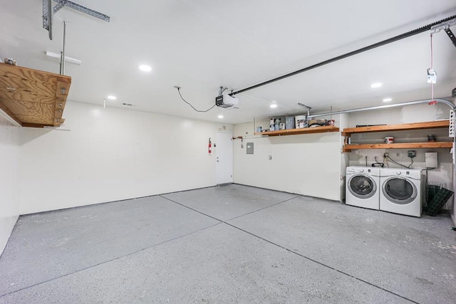 garage featuring a garage door opener and washing machine and dryer