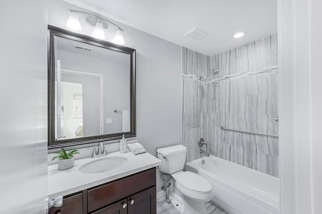 full bathroom featuring tiled shower / bath combo, vanity, and toilet