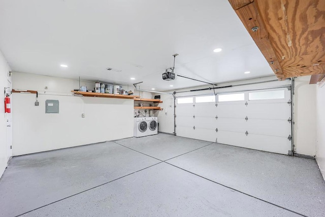 garage featuring a garage door opener and washer and dryer