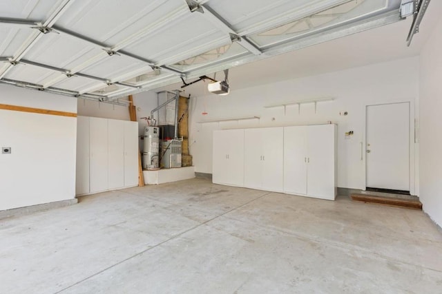 garage with a garage door opener and water heater