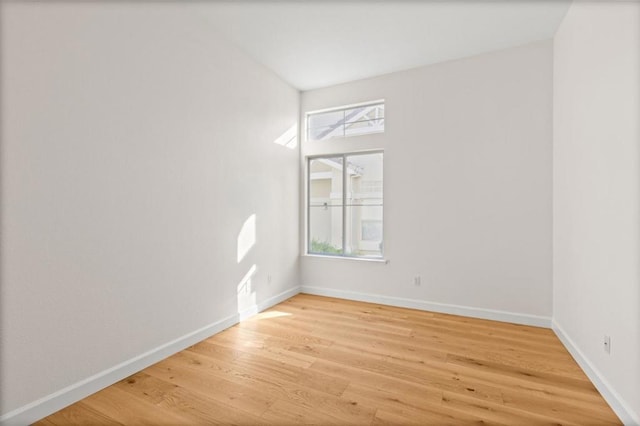 spare room with hardwood / wood-style floors