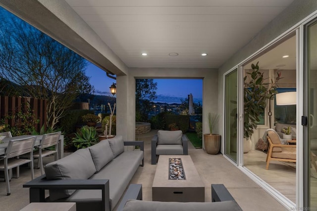 patio terrace at dusk featuring an outdoor living space