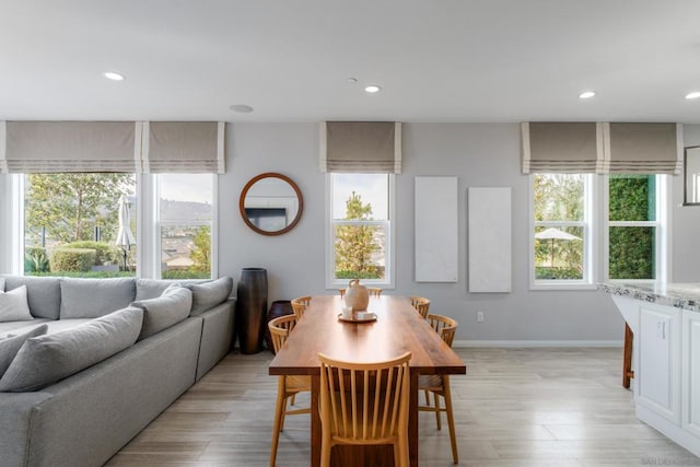 dining area with plenty of natural light and light wood-type flooring