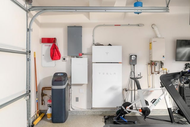 garage featuring white refrigerator and tankless water heater