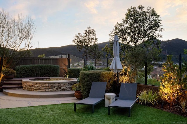 view of yard featuring a mountain view and an outdoor fire pit