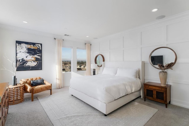 bedroom with ornamental molding and light carpet