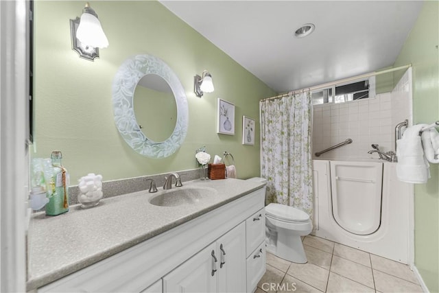 bathroom with tile patterned flooring, vanity, and toilet