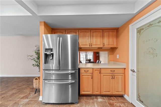 kitchen featuring stainless steel fridge with ice dispenser