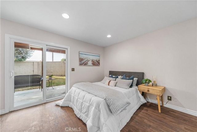 bedroom with access to exterior and dark hardwood / wood-style flooring