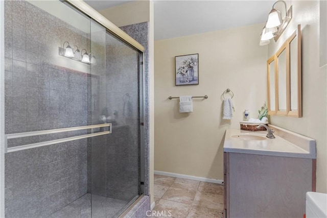 bathroom with vanity, toilet, and a shower with shower door