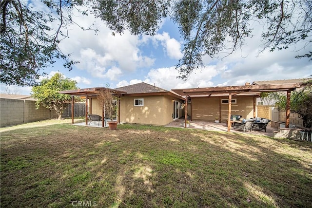 rear view of property featuring a lawn and a patio