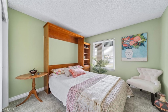 bedroom featuring carpet floors and a textured ceiling