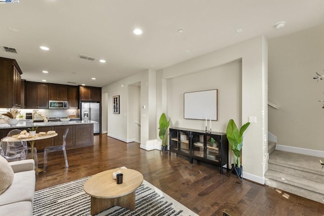 living room with sink and dark wood-type flooring