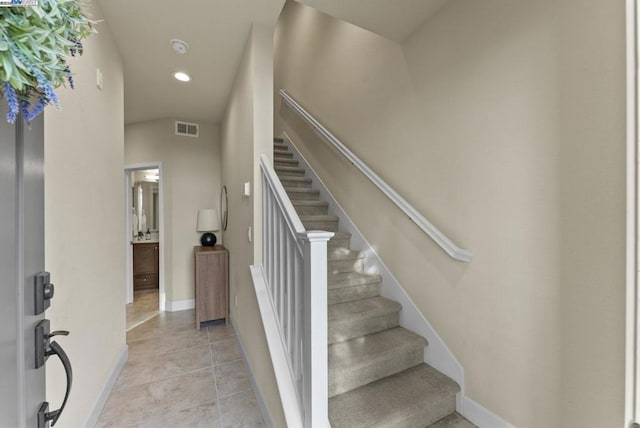 staircase featuring tile patterned floors