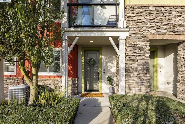 entrance to property featuring cooling unit