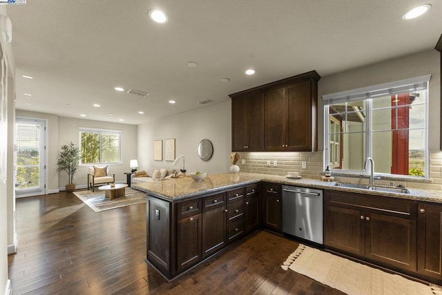 kitchen featuring dishwasher, sink, dark hardwood / wood-style flooring, kitchen peninsula, and light stone countertops