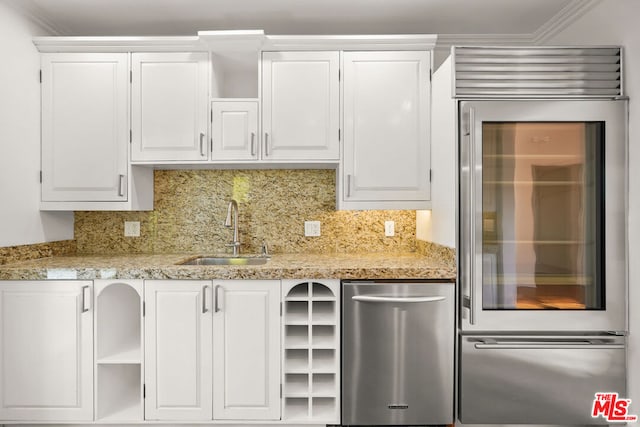 kitchen with white cabinetry, sink, and tasteful backsplash