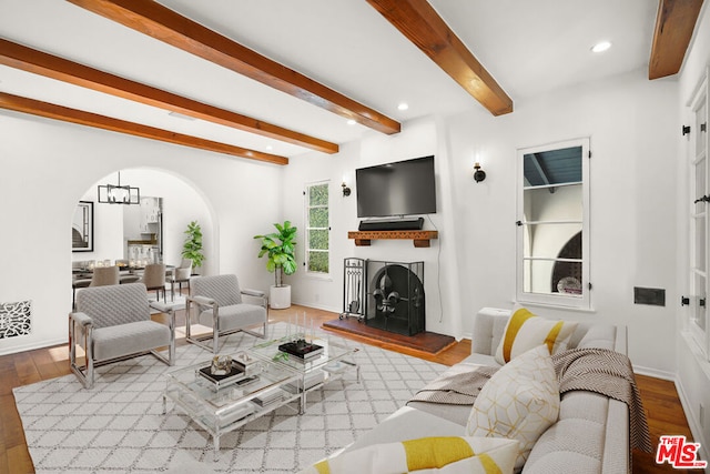 living room featuring light wood-type flooring and beam ceiling