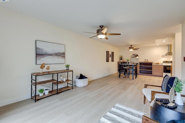 living room featuring ceiling fan and light wood-type flooring