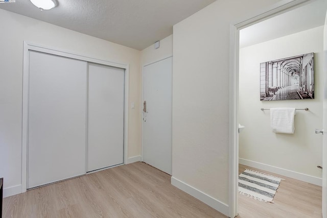 unfurnished bedroom with a closet and light hardwood / wood-style flooring