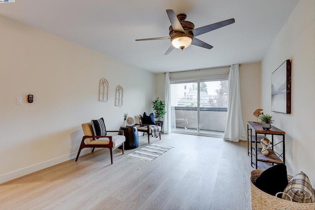 sitting room featuring ceiling fan and light wood-type flooring