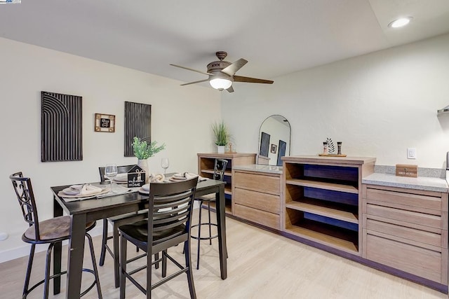 dining space featuring ceiling fan and light wood-type flooring