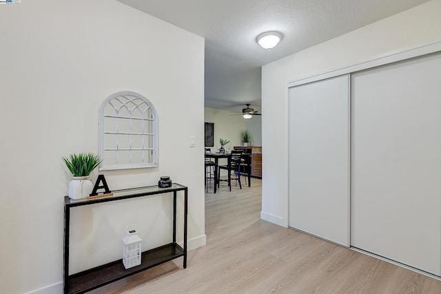 corridor with light hardwood / wood-style flooring