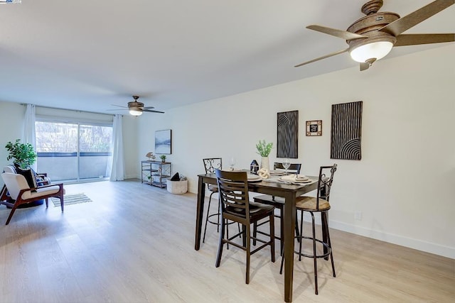 dining room with ceiling fan and light hardwood / wood-style floors