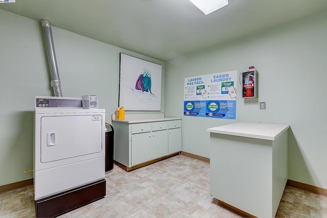 washroom with cabinets and washer / clothes dryer