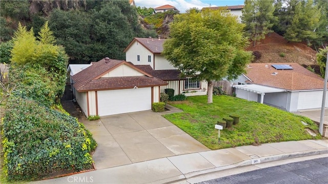 view of front of property featuring a garage and a front yard