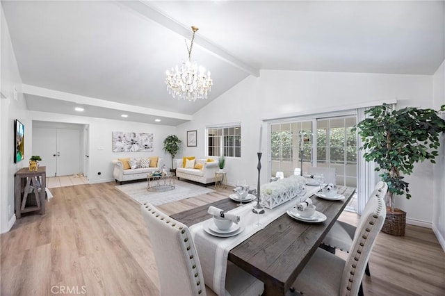 dining area with a notable chandelier, high vaulted ceiling, beamed ceiling, and light wood-type flooring