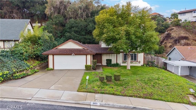 view of front of house with a garage and a front lawn