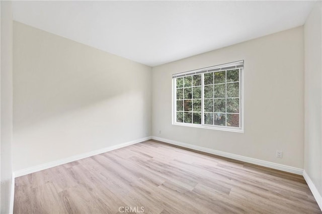 spare room with light hardwood / wood-style flooring