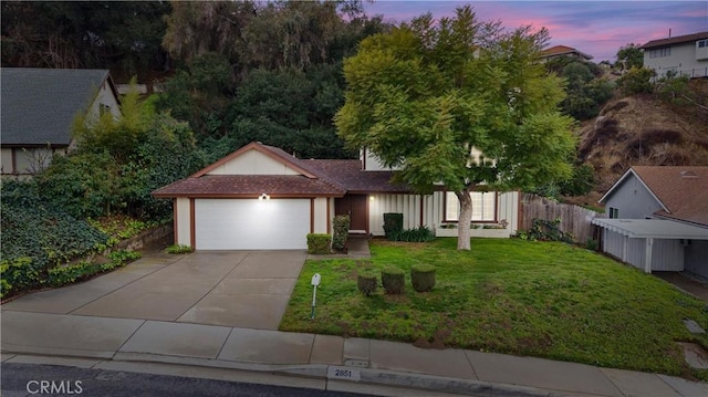 view of front of home featuring a garage and a lawn