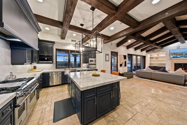 kitchen featuring stone tile floors, decorative backsplash, a kitchen island, stainless steel appliances, and recessed lighting