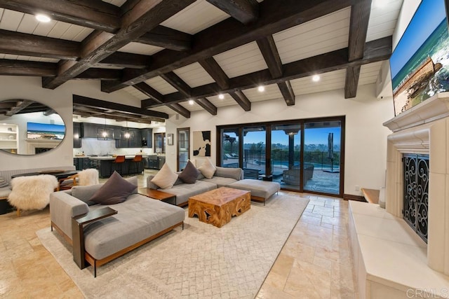 living room with vaulted ceiling with beams, recessed lighting, stone tile flooring, and baseboards