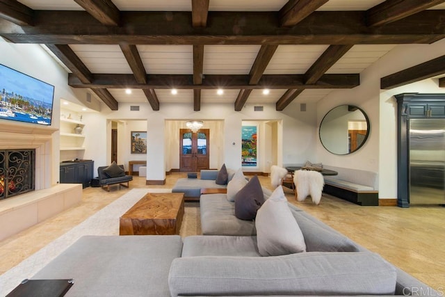 living area featuring visible vents, a fireplace, baseboards, and built in features