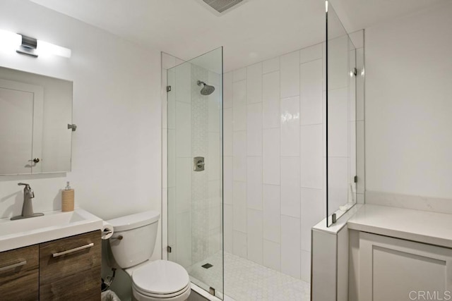 bathroom featuring visible vents, toilet, vanity, and a walk in shower