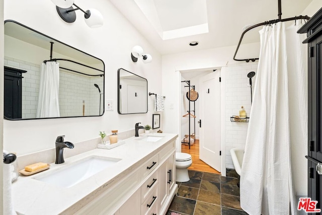 full bathroom featuring vanity, toilet, and shower / tub combo