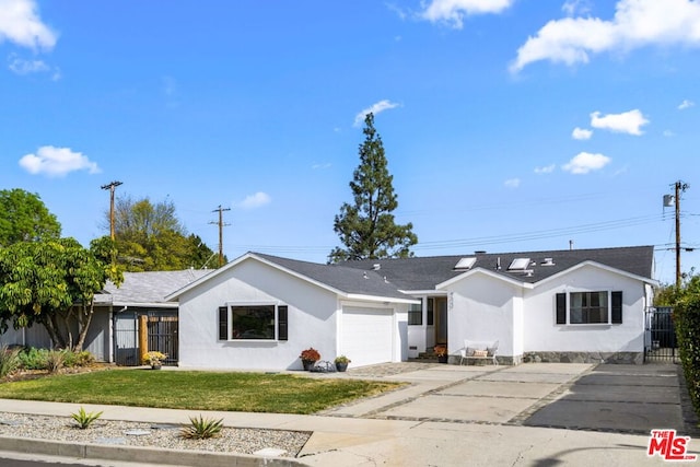 ranch-style house with a garage and a front lawn