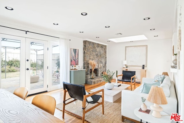 living room featuring french doors and light hardwood / wood-style floors