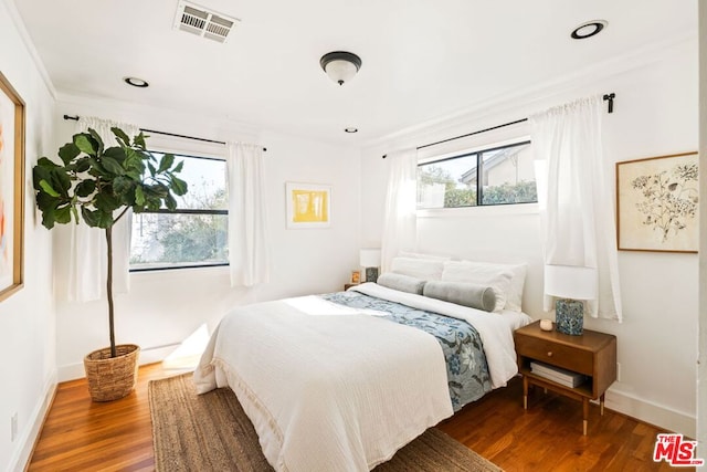 bedroom featuring hardwood / wood-style flooring and multiple windows