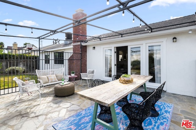 view of patio / terrace featuring a lanai