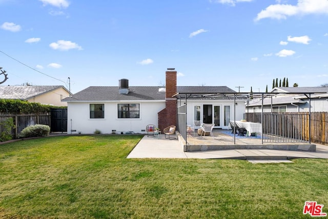 back of house with a yard and a patio area