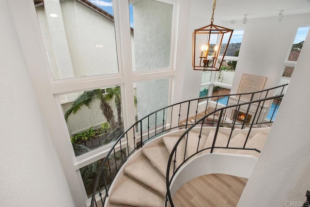 stairs with a chandelier