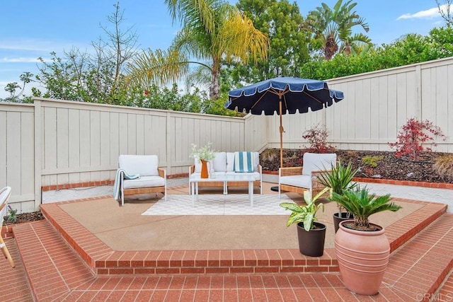 view of patio / terrace featuring an outdoor hangout area and a fenced backyard